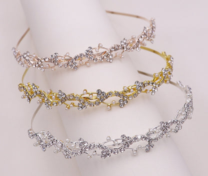 Three decorative headbands with floral designs on a white background