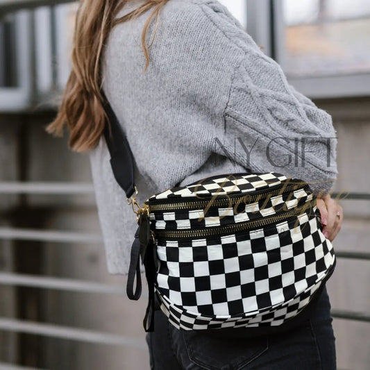 Person wearing a black and white checkered bag with a blurred background