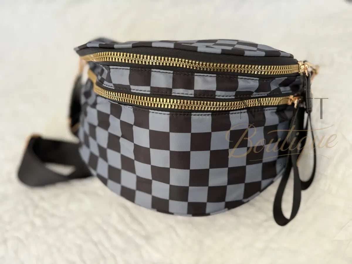 Checkered fanny pack with gold zipper on a light background