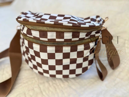 Brown and white checkered bag with a strap on a light background