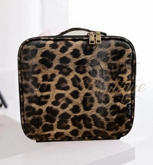 Leopard print makeup bag on a white surface with a blurred background