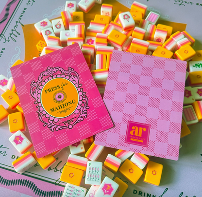 Sip & Shuffle Mahjong tile shufflers displayed with colorful Mahjong tiles on a coordinating game mat.